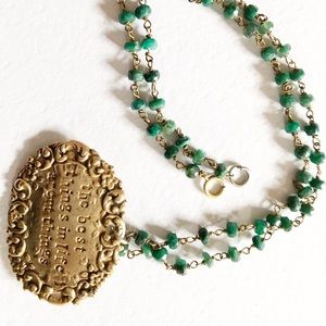 Brass finish and raw emerald necklace w charm.